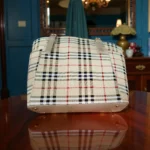 Bottom view of classic beige checkered tote showing base and metal feet