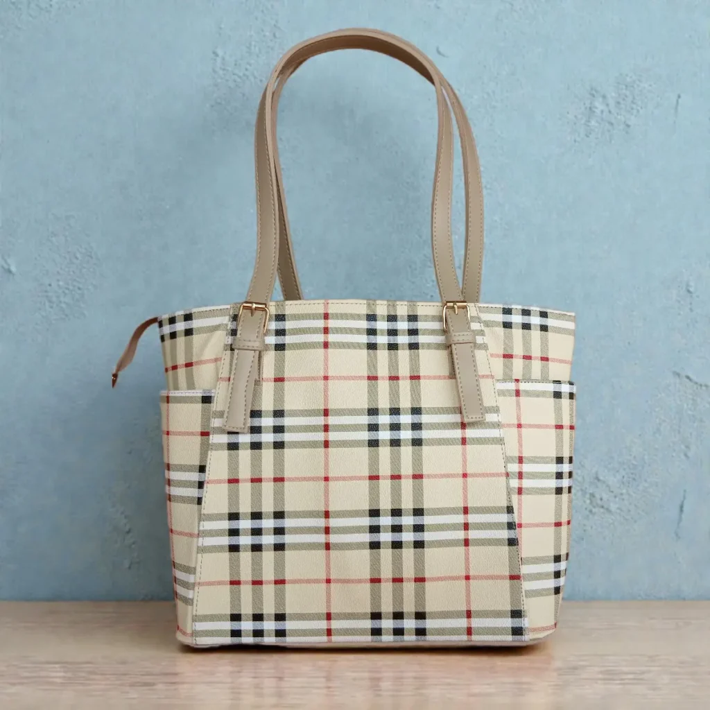 Classic beige checkered tote handbag with long dual straps against blue background
