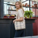 Model wearing beige classic checkered tote handbag on shoulder
