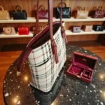 Side angle of classic checkered white tote handbag in store display