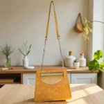 Mustard yellow embossed floral mini crossbody bag hanging by chain strap in a kitchen setup