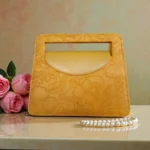 Embossed floral mini carry crossbody bag in mustard yellow front view with roses decoration