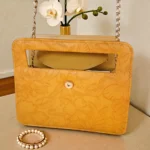 Rear panel view of mustard yellow mini crossbody bag with smooth leather back