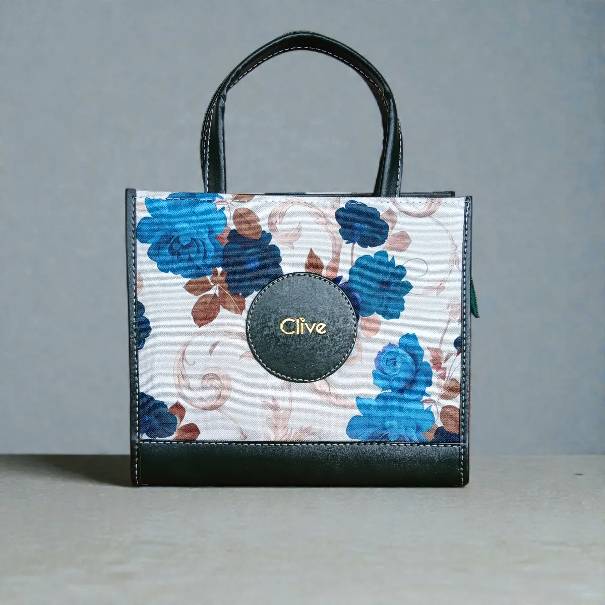 Fabric floral printed crossbody handbag in green color with blue flower design and short handles
