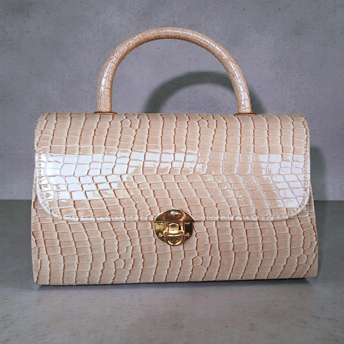 Glossy beige croc handbag front view