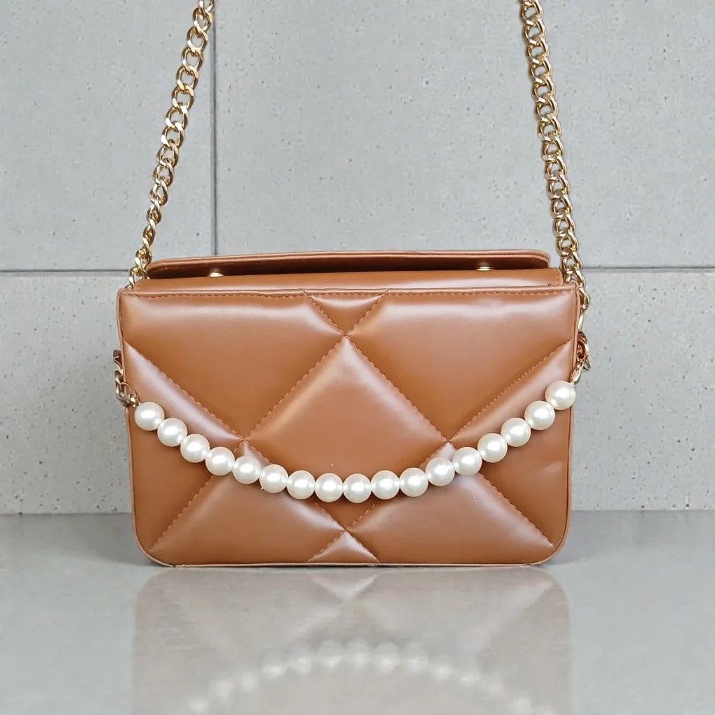 Front view of tan brown quilted crossbody bag with pearl chain detail