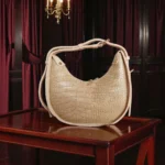 Textured beige crossbody bag with pearl chain back view