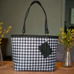 Black and white printed ladies tote bag with houndstooth pattern, long shoulder straps and detachable zip pouch