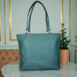 Back view of deep green ladies tote bag with smooth leather finish and dual straps