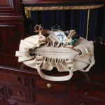 Top view of beige drawstring handbag showing zip closure and inner opening