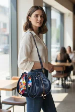 Drawstring handbag worn crossbody by model for size reference