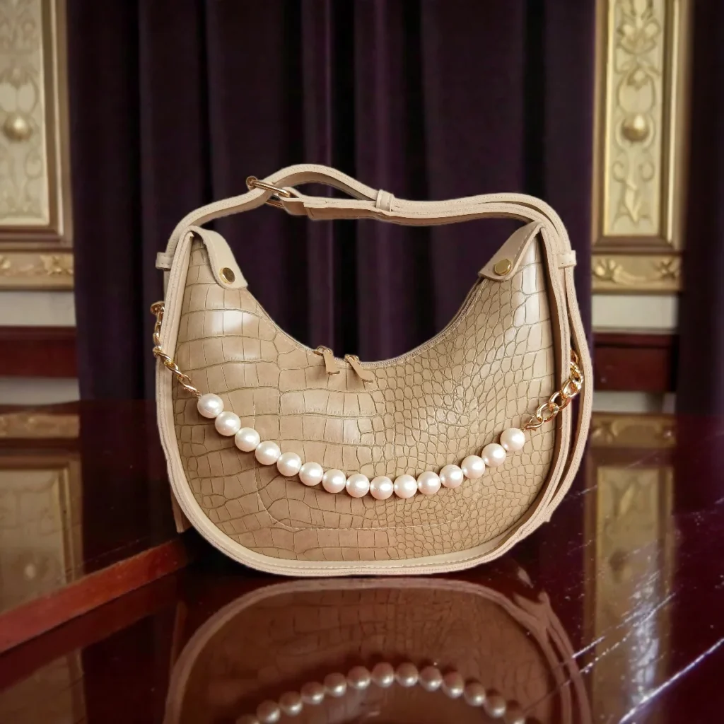 Textured beige crossbody bag with pearl chain front view