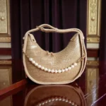 Textured beige crossbody bag with pearl chain front view