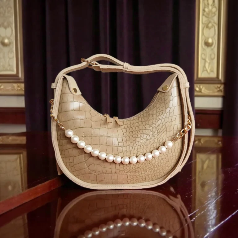 Textured beige crossbody bag with pearl chain front view
