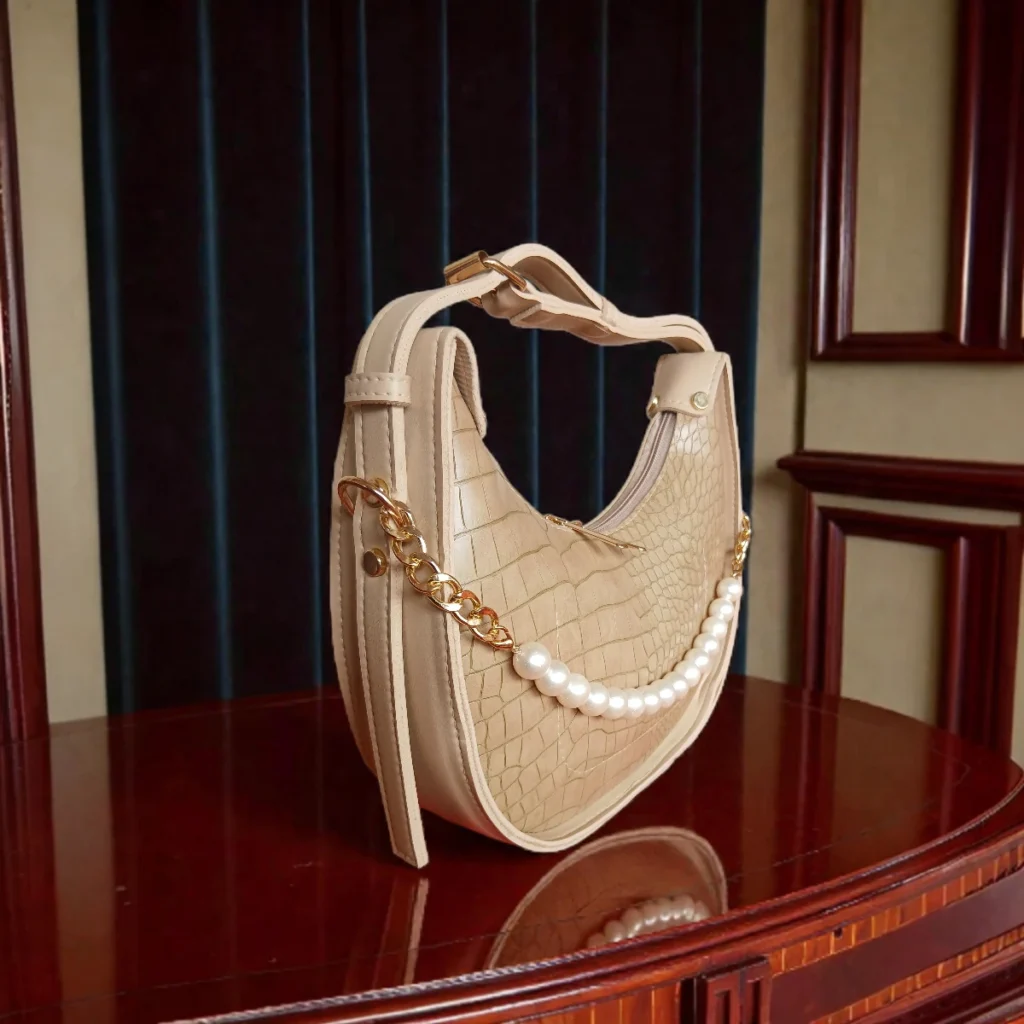Beige textured crossbody bag side angle showing pearl detail