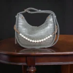 Textured grey crossbody bag with pearl chain detail front view