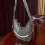 Textured grey crossbody bag back view with adjustable strap