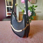 Close-up of navy blue bag showing pearl chain and texture