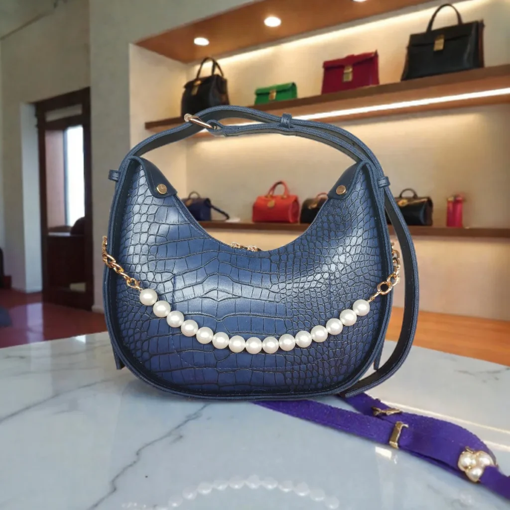 Textured navy blue crossbody bag with pearl chain front view