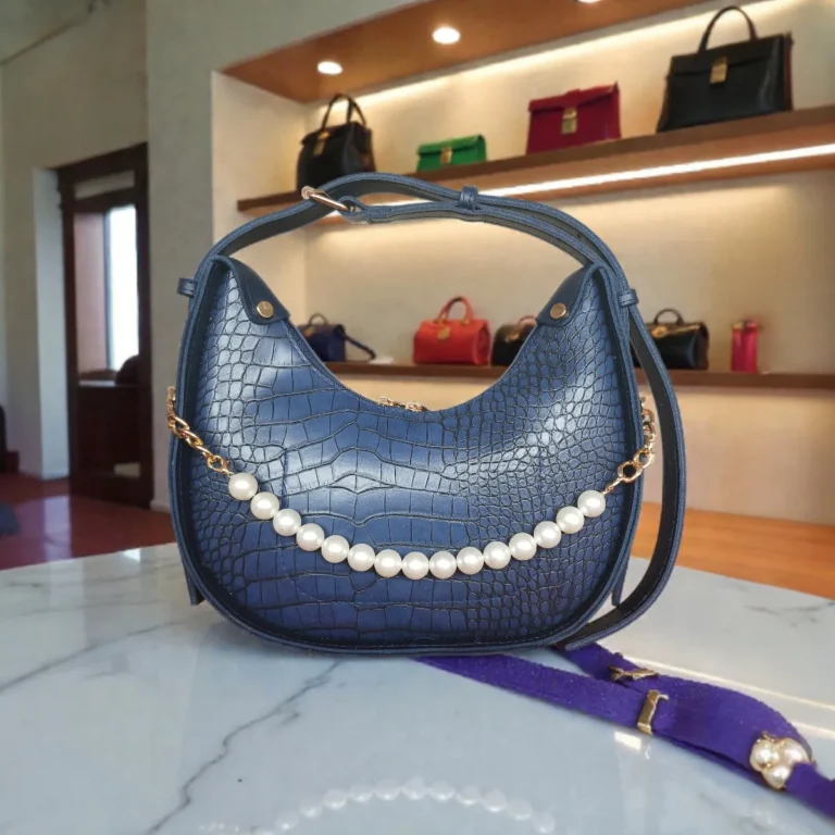 Textured navy blue crossbody bag with pearl chain front view