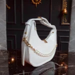 White textured crossbody bag side angle with pearl chain
