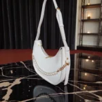 White textured crossbody bag top view showing zip closure