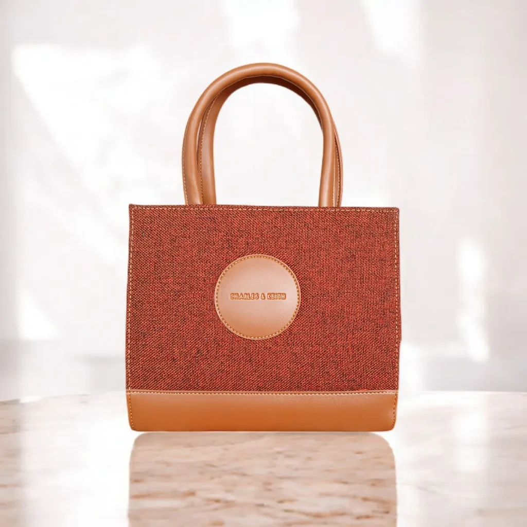 Brown tweed crossbody handbag with top handles front view