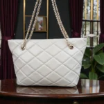 Front view of Ivory Cream diamond quilted tote bag with double gold chain handles