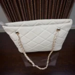 Top angle view of Ivory Cream quilted tote bag showing gold chain straps and zipper pull