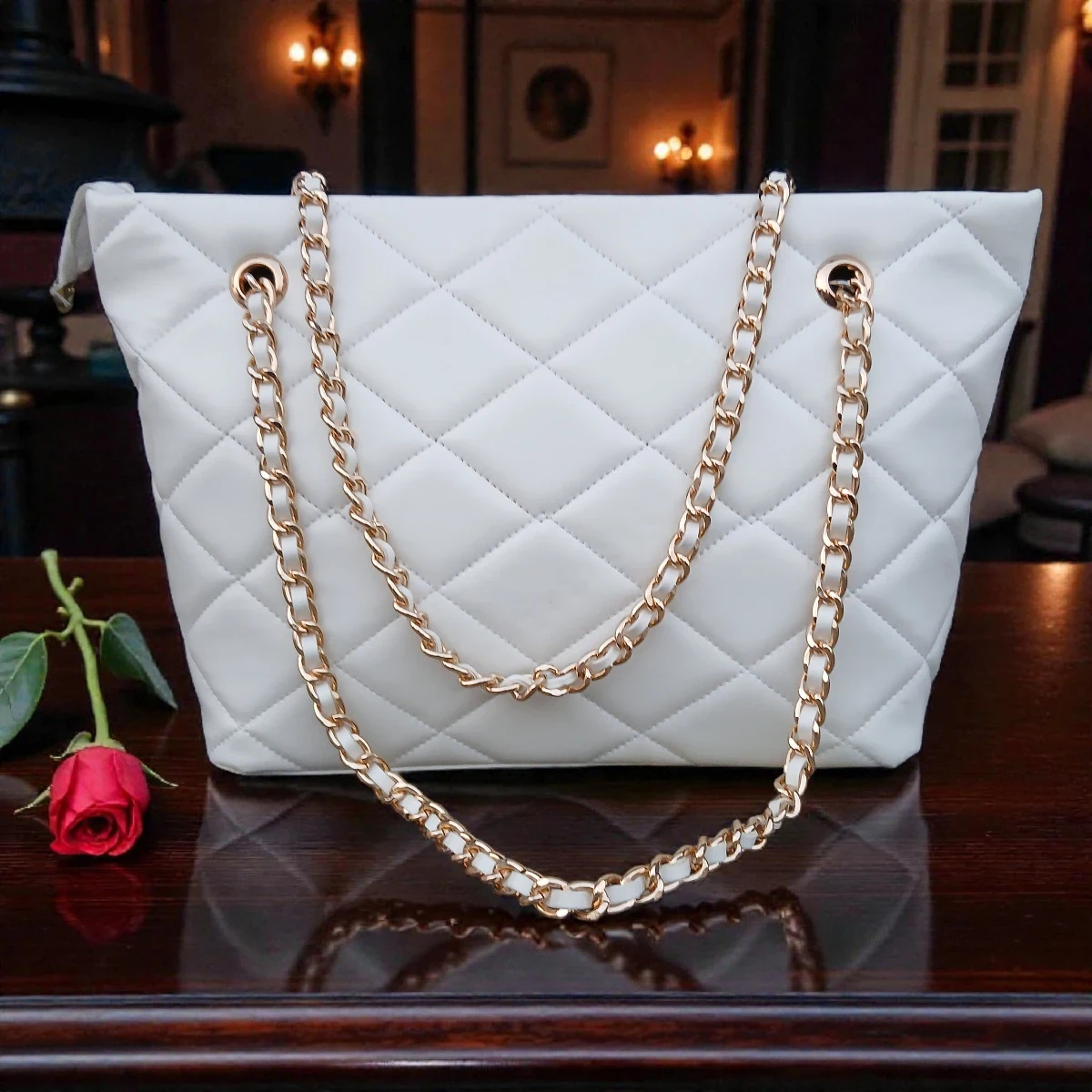 Classic Quilted Chain Strap Tote Bag Pearl White with diamond quilted pattern and gold chain shoulder straps displayed on wooden table with red rose decor