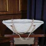 Top view of pearl white quilted chain strap tote bag showing zipper closure and spacious opening