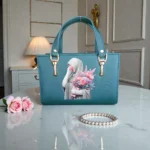 Printed Portrait Mini Structured Top Handle Crossbody Emerald Green front view with portrait print artwork and top handles on display table